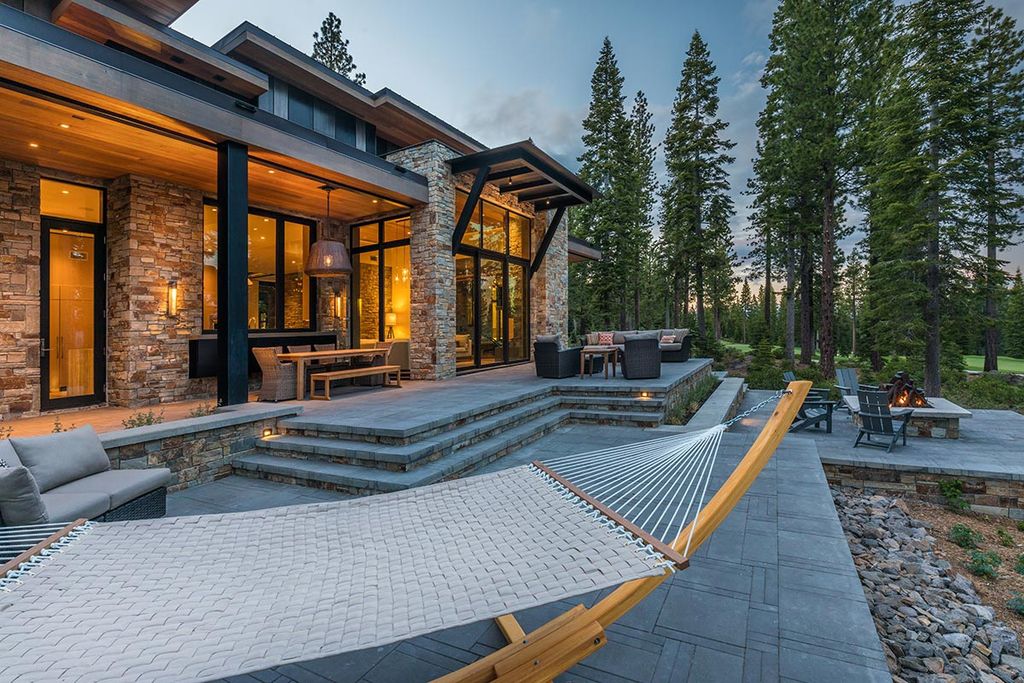 Martis Camp Home Lot 53 in Truckee, California was designed by Dennis Zirbel Architects in mountain contemporary style; this house offers impressive mountain views and expansive indoors and outdoors entertaining.