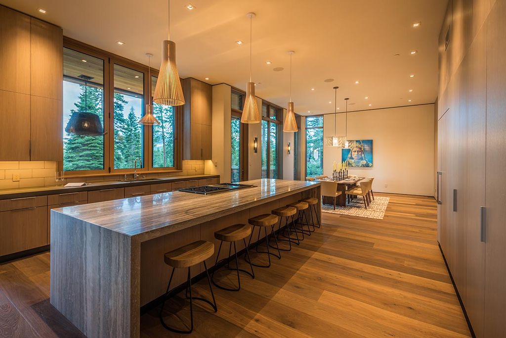 Martis Camp Home Lot 53 in Truckee, California was designed by Dennis Zirbel Architects in mountain contemporary style; this house offers impressive mountain views and expansive indoors and outdoors entertaining.