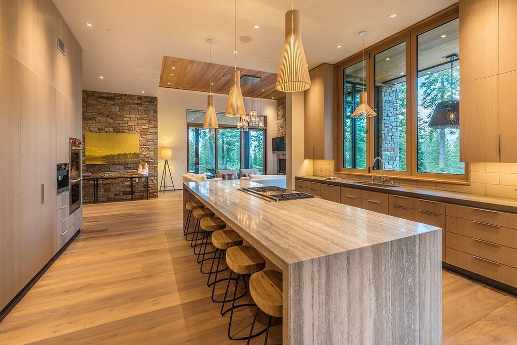 Martis Camp Home Lot 53 in Truckee, California was designed by Dennis Zirbel Architects in mountain contemporary style; this house offers impressive mountain views and expansive indoors and outdoors entertaining.