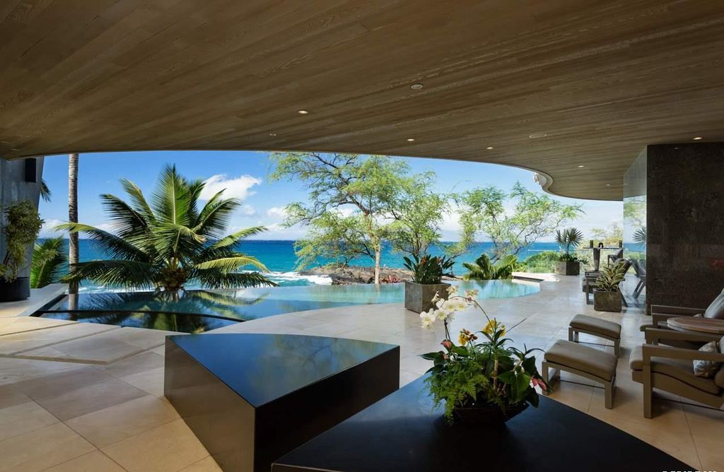 Makena Contemporary House in Kihei, Hawii perfectly situated on an intimate cove was designed by Guy Dreier Designs in tropical Modern style; this house is a livable work of art with its soaring ceilings, dramatic finishes, and innovative floor plan. 