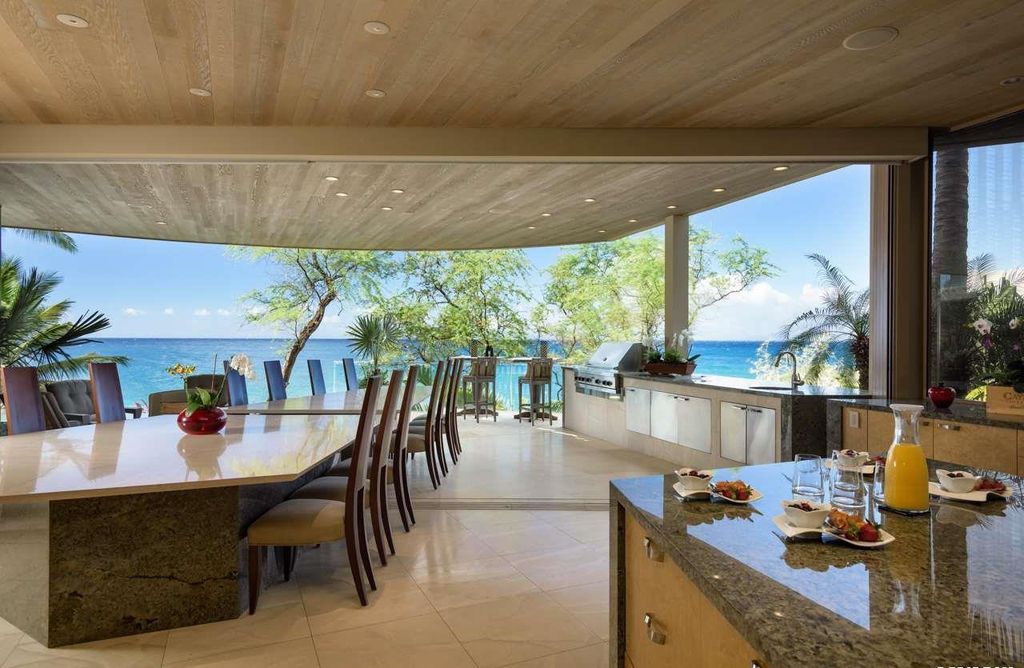 Makena Contemporary House in Kihei, Hawii perfectly situated on an intimate cove was designed by Guy Dreier Designs in tropical Modern style; this house is a livable work of art with its soaring ceilings, dramatic finishes, and innovative floor plan. 