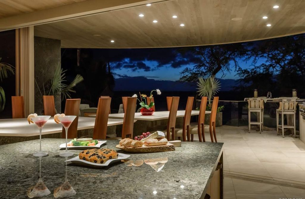 Makena Contemporary House in Kihei, Hawii perfectly situated on an intimate cove was designed by Guy Dreier Designs in tropical Modern style; this house is a livable work of art with its soaring ceilings, dramatic finishes, and innovative floor plan. 