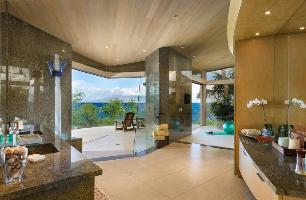 Makena Contemporary House in Kihei, Hawii perfectly situated on an intimate cove was designed by Guy Dreier Designs in tropical Modern style; this house is a livable work of art with its soaring ceilings, dramatic finishes, and innovative floor plan. 