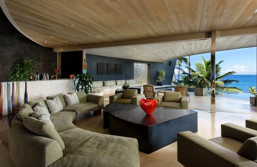 Makena Contemporary House in Kihei, Hawii perfectly situated on an intimate cove was designed by Guy Dreier Designs in tropical Modern style; this house is a livable work of art with its soaring ceilings, dramatic finishes, and innovative floor plan. 