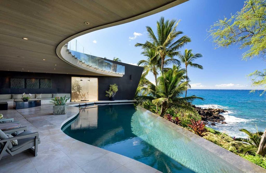 Makena Contemporary House in Kihei, Hawii perfectly situated on an intimate cove was designed by Guy Dreier Designs in tropical Modern style; this house is a livable work of art with its soaring ceilings, dramatic finishes, and innovative floor plan. 