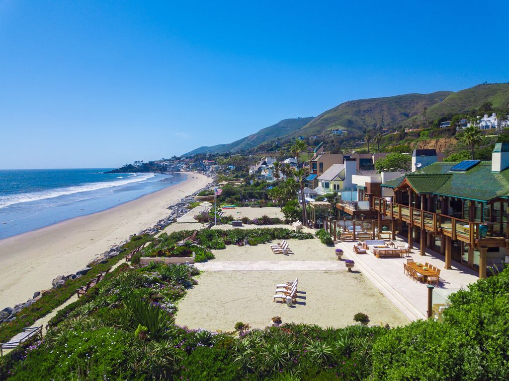 The Malibu Mansion is a Thai-inspired oasis on a rare parcel of more than one acre with approximately 117 feet of beachfront now available for sale. This home located at 31118 Broad Beach Rd, Malibu, California; offering 5 bedrooms and 14 bathrooms with over 17,000 square feet of living spaces.
