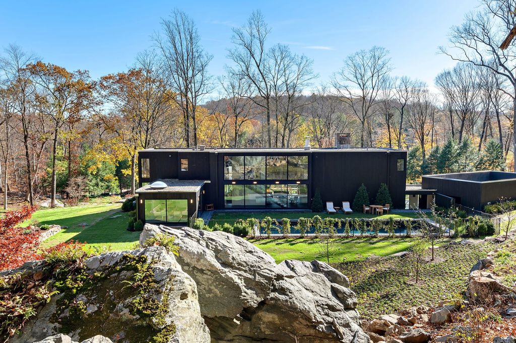 The Contemporary Home in Bedford perfectly sited on over 5 private, tranquil acres with sweeping drive and gated entry now available for sale. This home located at 147 Mianus River Rd, Bedford, New York; offering 5 bedrooms and 5 bathrooms with over 3,900 square feet of living spaces.