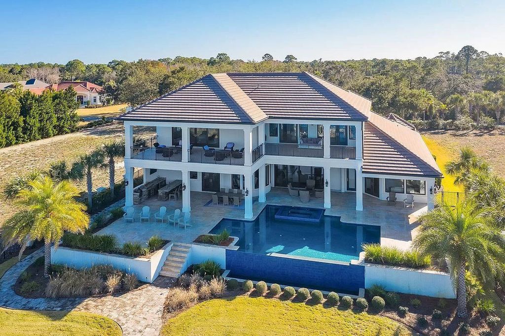 The Florida Retreat is a sprawling bay front home on premier homesites in the prestigious gated enclave of Regatta Bay now available for sale. This home located at 4532 Fairwind Ct, Destin, Florida; offering 4 bedrooms and 6 bathrooms with over 5,700 square feet of living spaces.