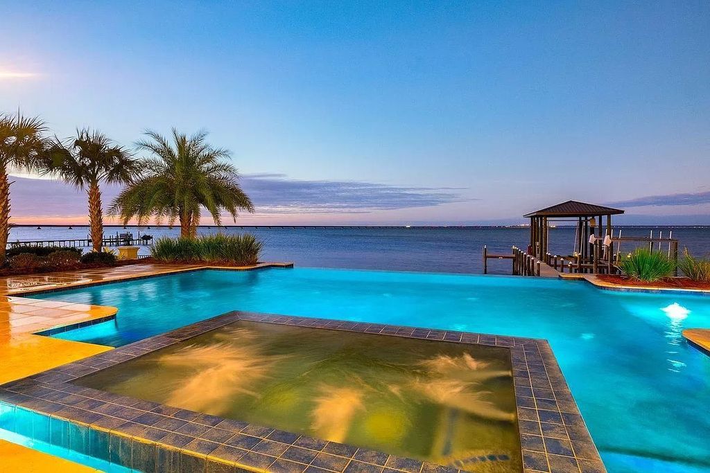 The Florida Retreat is a sprawling bay front home on premier homesites in the prestigious gated enclave of Regatta Bay now available for sale. This home located at 4532 Fairwind Ct, Destin, Florida; offering 4 bedrooms and 6 bathrooms with over 5,700 square feet of living spaces.