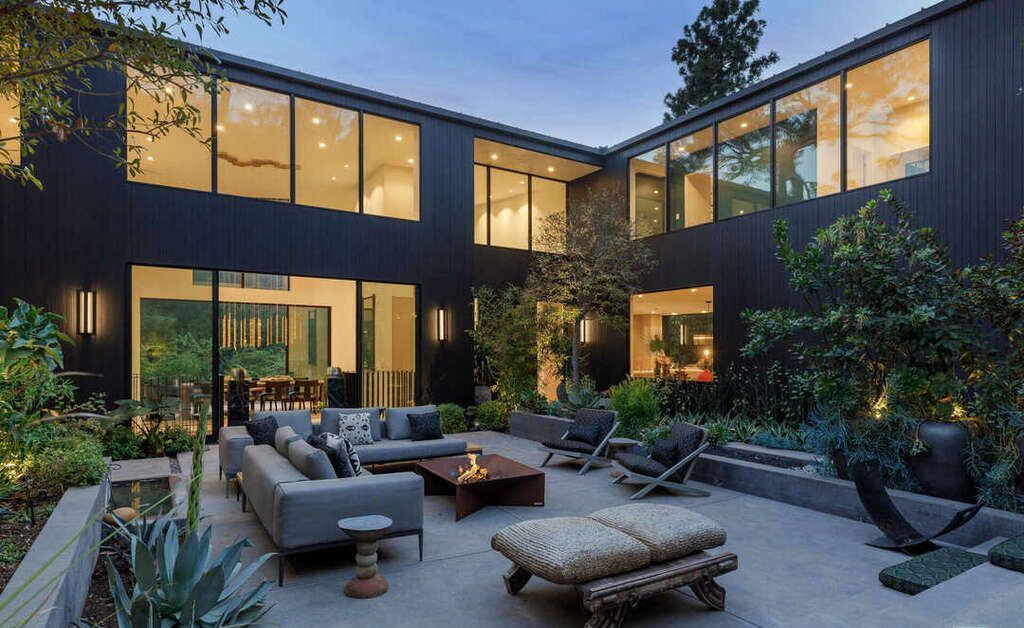 The Hollywood Hills Home is a zen-inspired architectural gem Located on a quiet, gated cul-de-sac lot is surrounded by trees, mature landscaping now available for sale. This home located at 7631 Willow Glen Rd, Los Angeles, California; offering 6 bedrooms and 8 bathrooms with over 10,000 square feet of living spaces.