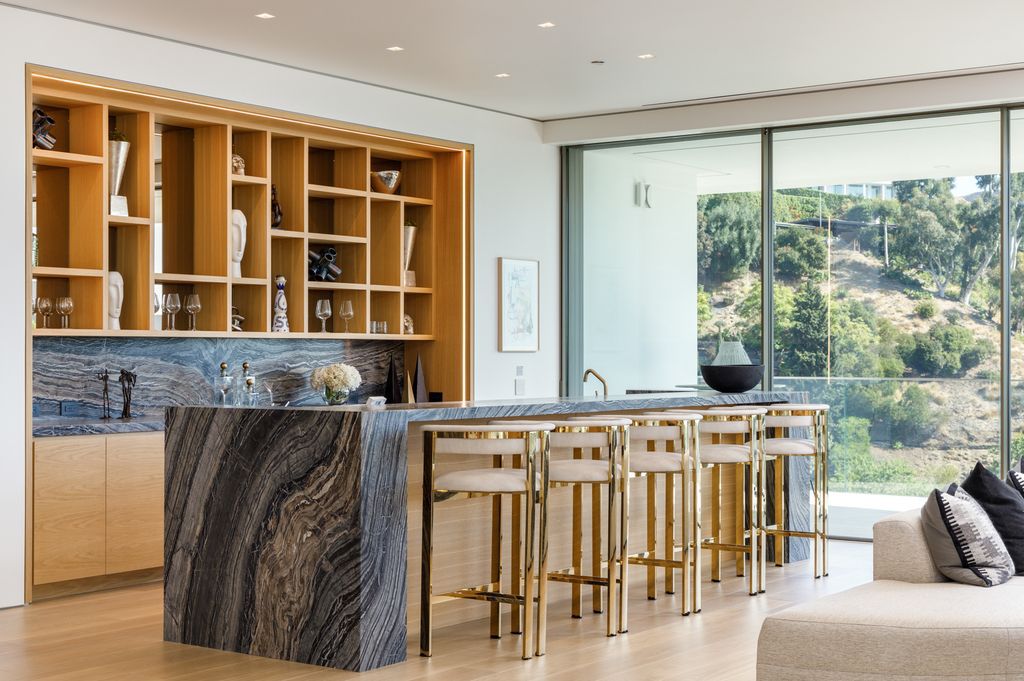 The Hollywood Hills Mansion is an amenity-rich entertainer’s paradise within walking distance to the iconic Sunset Strip now available for sale. This home located at 1422 Devlin Dr, Los Angeles, California; offering 6 bedrooms and 10 bathrooms with over 10,000 square feet of living spaces.