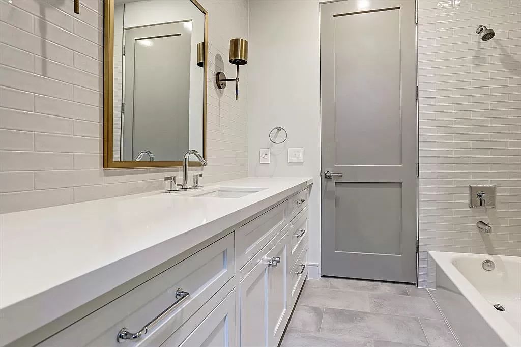 Choose small subway tiles for your bathroom backsplash for an unexpected variation on a classic aesthetic. The beveled-edge feature on this small-scale tile adds texture. Extend the neutral backsplash to the ceiling to visually enlarge a tiny bathroom.