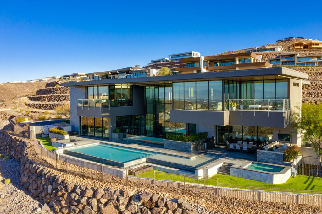 The Modern Home in the Las Vegas Valley is a distinctively modern estate offers a unique opportunity to live in a piece of art now available for sale. This home located at 7 Talus Ct, Henderson, Nevada; offering 6 bedrooms and 8 bathrooms with over 10,800 square feet of living spaces.