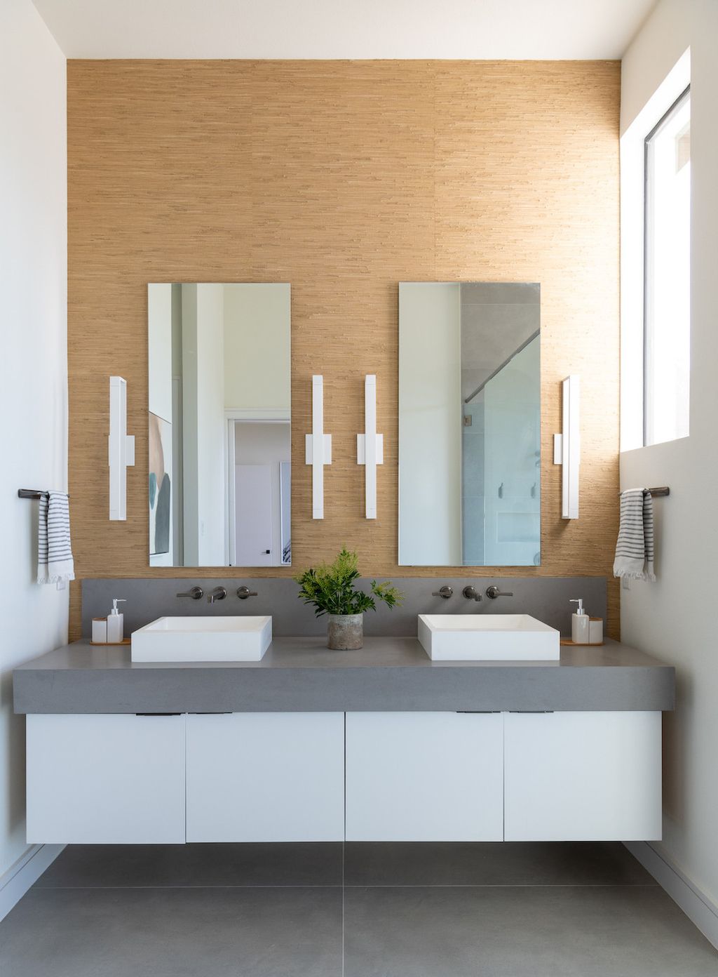 Opt for natural stone tiles like travertine or marble in neutral tones. These materials can add a touch of luxury and sophistication to the bathroom, while still blending nicely with the wooden elements.