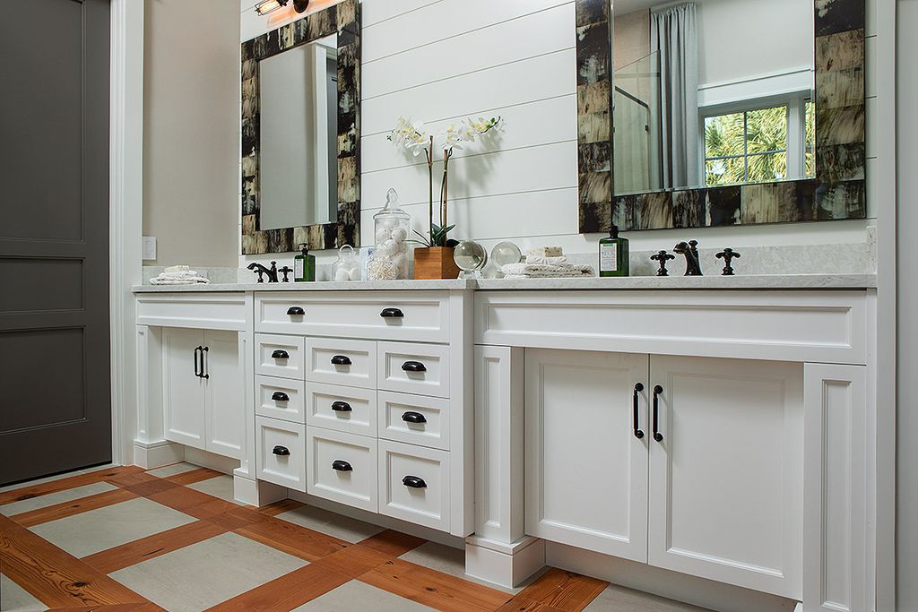 The wood planks cut from 8-foot lengths make a farmhouse-style statement. Install the boards on one wall, then add texture with a light gray stain. The rustic tones of this wood bathroom backsplash are enhanced with a granite countertop.