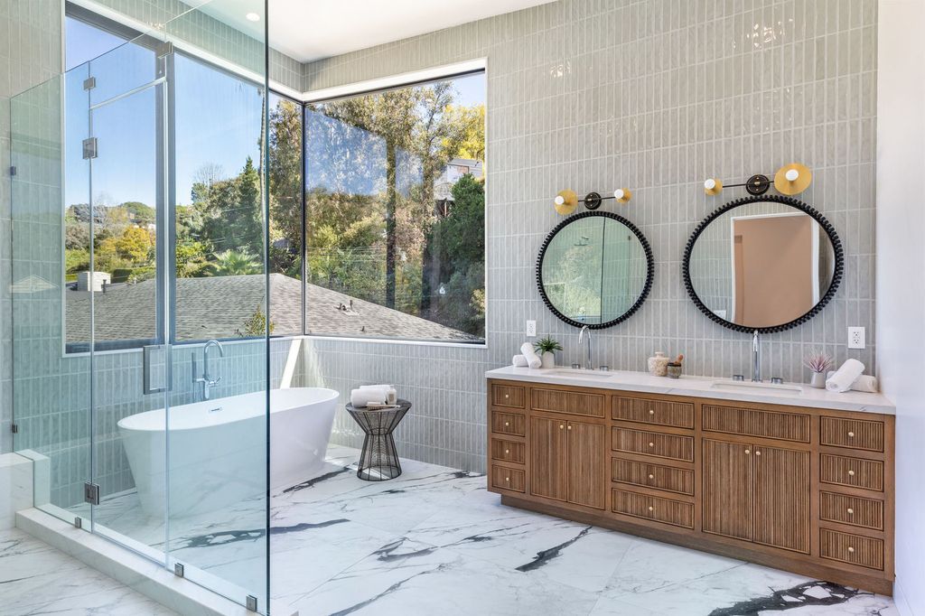 Choose small subway tiles for your bathroom backsplash for an unexpected variation on a classic aesthetic. The beveled-edge feature on this small-scale tile adds texture. Extend the neutral backsplash to the ceiling to visually enlarge a tiny bathroom.