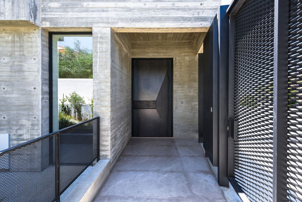 Concrete House in Cyprus was designed by Markella Menikou Chartered Architect in contemporary style with seamless extension to the outside; this house offers modern living with high end finishes and smart amenities. 