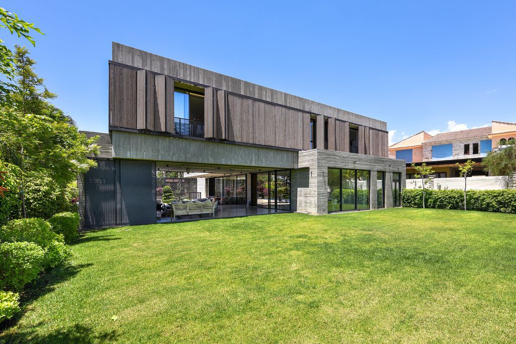Concrete House in Cyprus was designed by Markella Menikou Chartered Architect in contemporary style with seamless extension to the outside; this house offers modern living with high end finishes and smart amenities. 