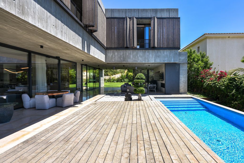 Concrete House in Cyprus was designed by Markella Menikou Chartered Architect in contemporary style with seamless extension to the outside; this house offers modern living with high end finishes and smart amenities. 