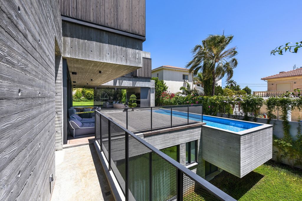 Concrete House in Cyprus was designed by Markella Menikou Chartered Architect in contemporary style with seamless extension to the outside; this house offers modern living with high end finishes and smart amenities. 