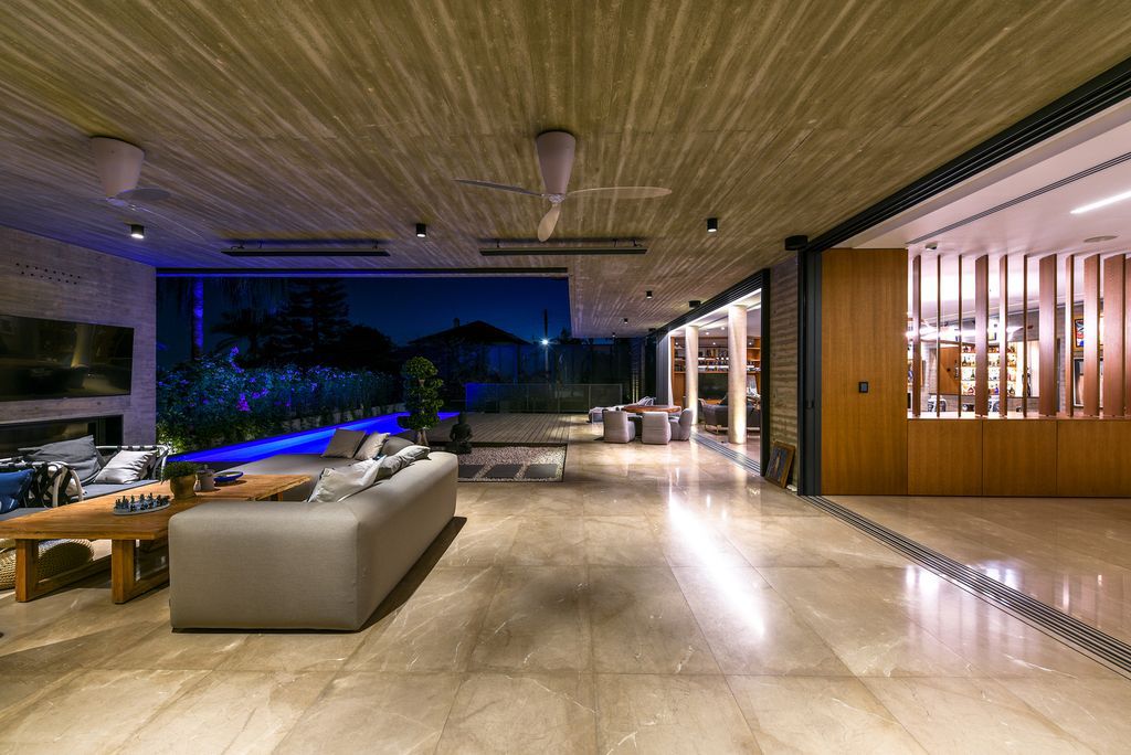 Concrete House in Cyprus was designed by Markella Menikou Chartered Architect in contemporary style with seamless extension to the outside; this house offers modern living with high end finishes and smart amenities. 