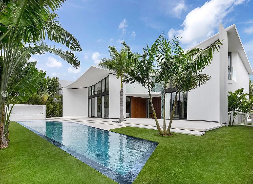 The Miami Beach Home is a new residence designed by world design star Achille Salvagni with a 90 ft infinity pool and private boat dock now available for sale. This home located at 810 Lakeview Dr, Miami Beach, Florida; offering 7 bedrooms and 7 bathrooms with over 7,900 square feet of living spaces.