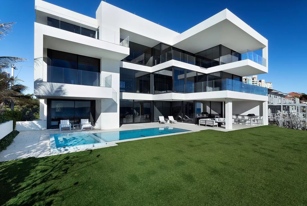 The Modern Mansion in Highland Beach is a gated modern Malibu-inspired ocean to intracoastal Estate now available for sale. This home located at 3833 S Ocean Blvd, Highland Beach, Florida; offering 5 bedrooms and 9 bathrooms with over 8,800 square feet of living spaces.