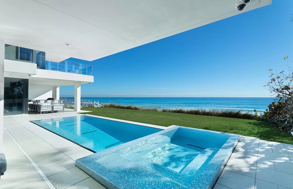 The Modern Mansion in Highland Beach is a gated modern Malibu-inspired ocean to intracoastal Estate now available for sale. This home located at 3833 S Ocean Blvd, Highland Beach, Florida; offering 5 bedrooms and 9 bathrooms with over 8,800 square feet of living spaces.