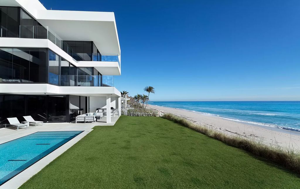 The Modern Mansion in Highland Beach is a gated modern Malibu-inspired ocean to intracoastal Estate now available for sale. This home located at 3833 S Ocean Blvd, Highland Beach, Florida; offering 5 bedrooms and 9 bathrooms with over 8,800 square feet of living spaces.
