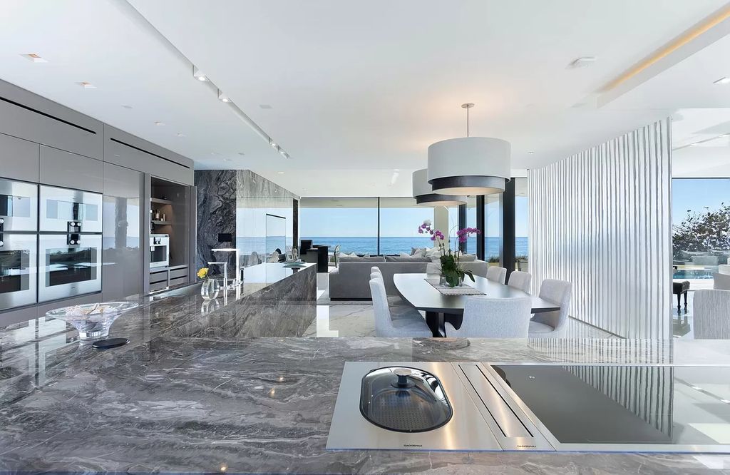 The Modern Mansion in Highland Beach is a gated modern Malibu-inspired ocean to intracoastal Estate now available for sale. This home located at 3833 S Ocean Blvd, Highland Beach, Florida; offering 5 bedrooms and 9 bathrooms with over 8,800 square feet of living spaces.