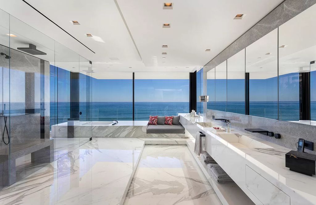 The Modern Mansion in Highland Beach is a gated modern Malibu-inspired ocean to intracoastal Estate now available for sale. This home located at 3833 S Ocean Blvd, Highland Beach, Florida; offering 5 bedrooms and 9 bathrooms with over 8,800 square feet of living spaces.