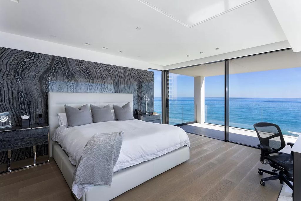 The Modern Mansion in Highland Beach is a gated modern Malibu-inspired ocean to intracoastal Estate now available for sale. This home located at 3833 S Ocean Blvd, Highland Beach, Florida; offering 5 bedrooms and 9 bathrooms with over 8,800 square feet of living spaces.