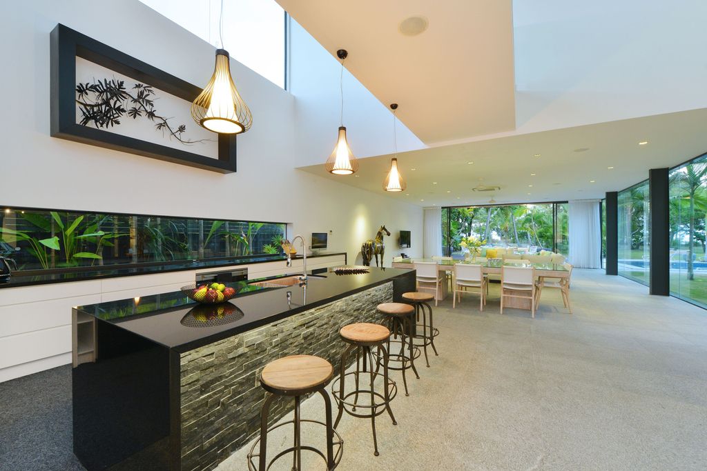 The Queensland Home is a stunning modern masterpiece with contemporary furnishings and bathed in natural light now available for rent. This home located at 50 Kewarra Street, Kewarra Beach, Queensland, Australia; offering 5 bedrooms and 7 bathrooms with over 1,200 square meter of living spaces.