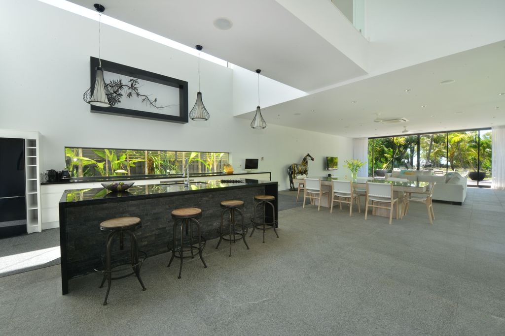 The Queensland Home is a stunning modern masterpiece with contemporary furnishings and bathed in natural light now available for rent. This home located at 50 Kewarra Street, Kewarra Beach, Queensland, Australia; offering 5 bedrooms and 7 bathrooms with over 1,200 square meter of living spaces.