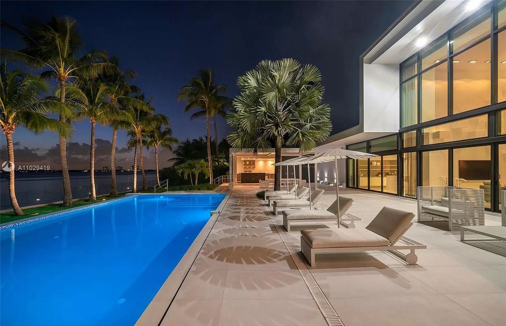 The Modern Mansion in Miami Beach is a stunning new 2-story waterfront estate and adjacent lot featuring resort style living now available for sale. This home located at 1050-1070 S Shore Dr #1070, Miami Beach, Florida; offering 6 bedrooms and 8 bathrooms with over 6,000 square feet of living spaces.