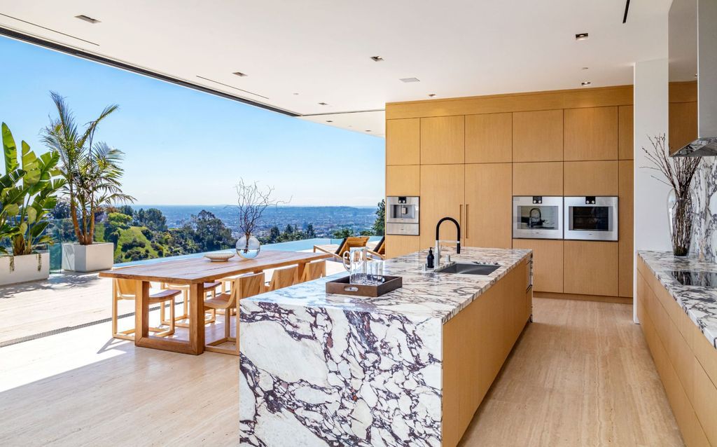 The Beverly Hills Mansion is an organic modern masterpiece set on Located on a picturesque acre featuring automated lifestyle now available for sale. This home located at 1274 Lago Vista Dr, Beverly Hills, California; offering 6 bedrooms and 8 bathrooms with over 13,000 square feet of living spaces.