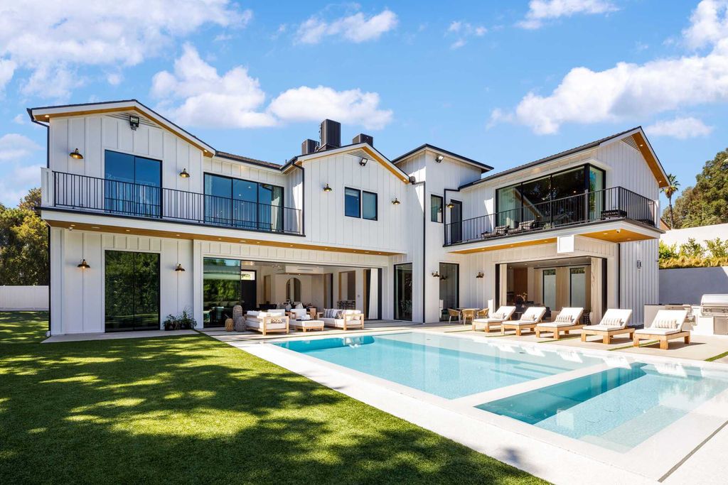 The Modern Farmhouse in Encino is a marvel at the grand scale, gorgeous fixtures, layered textures, and sleek design now available for sale. This home located at 17015 Adlon Rd, Encino, California; offering 6 bedrooms and 10 bathrooms with over 8,900 square feet of living spaces. 