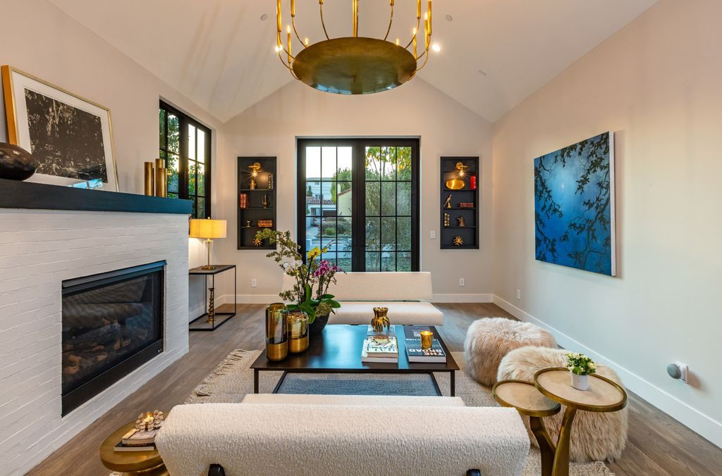 A simple yet eye-catching neutral color palette for living rooms is black and white. In this shiplap-covered living room, the white is contrasted with a black paneled accent wall. The placement of the black and off-white furnishings in the living room is done such to emphasize the contrast between the two neutral colors. To give the dark hue some life, choose black paint colors with a slightly reflecting finish, like satin or semi-gloss.