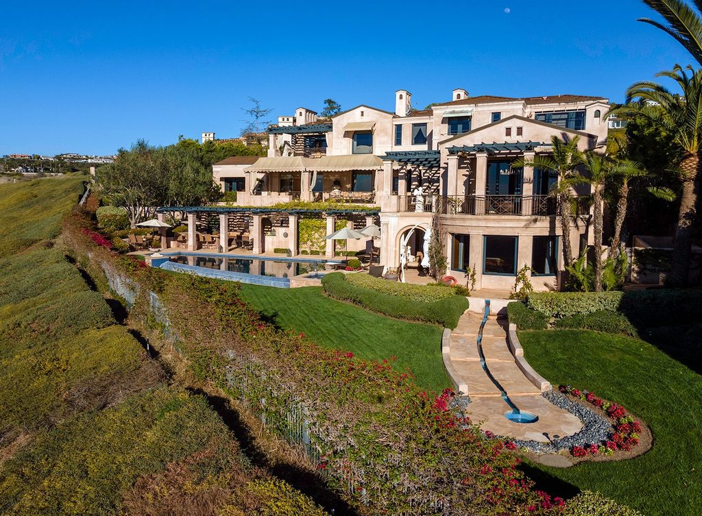 The Newport Beach Villa is an ultra-private retreat on an extraordinary oversized lot encompassing a front row span of unimpeded view now available for sale. This home located at 3 Rim Rdg, Newport Beach, California; offering 6 bedrooms and 8 bathrooms with over 11,300 square feet of living spaces.