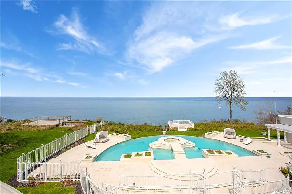 The Beachfront Home in Port Jefferson with a gated entry on 8.5 acres, boasting 310 feet of prime beach frontage now available for sale. This home located at 1 Osprey Ct, Pt Jefferson, New York; offering 11 bedrooms and 18 bathrooms with over 20,000 square feet of living spaces.