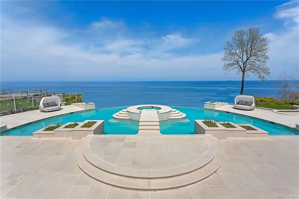 The Beachfront Home in Port Jefferson with a gated entry on 8.5 acres, boasting 310 feet of prime beach frontage now available for sale. This home located at 1 Osprey Ct, Pt Jefferson, New York; offering 11 bedrooms and 18 bathrooms with over 20,000 square feet of living spaces.