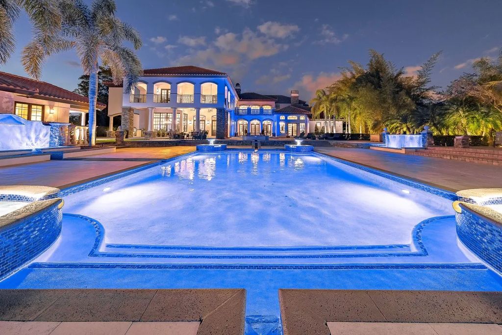 The Home in Parkland is a luxurious home with updates and Smart Home features, including a theater, custom wine cellar, saltwater pool now available for sale. This home located at 9136 NW 66th Ln, Parkland, Flordia; offering 7 bedrooms and 9 bathrooms with over 17,000 square feet of living spaces.