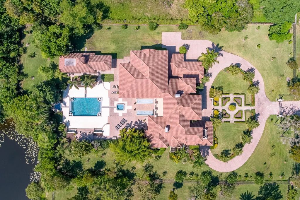 The Home in Parkland is a luxurious home with updates and Smart Home features, including a theater, custom wine cellar, saltwater pool now available for sale. This home located at 9136 NW 66th Ln, Parkland, Flordia; offering 7 bedrooms and 9 bathrooms with over 17,000 square feet of living spaces.