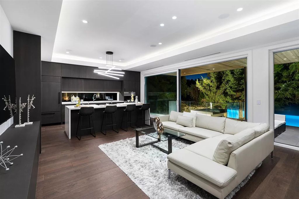 A simple yet eye-catching neutral color palette for living rooms is black and white. In this shiplap-covered living room, the white is contrasted with a black paneled accent wall. The placement of the black and off-white furnishings in the living room is done such to emphasize the contrast between the two neutral colors. To give the dark hue some life, choose black paint colors with a slightly reflecting finish, like satin or semi-gloss.