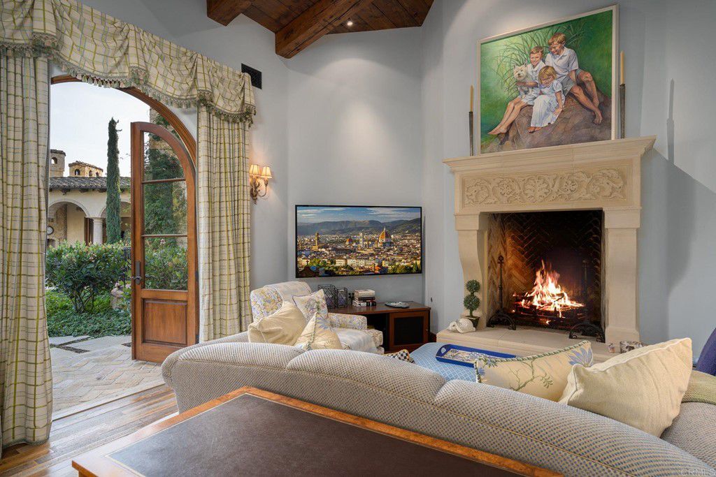 In this neutral living room, the use of cool gray and clean white creates a contemporary atmosphere. Warmth is added to the palette by richly stained wood floors and a few wooden furnishings. The deeper wood tones serve as a solid foundation for the room and prevent the neutral living room hues from looking too sterile or washed out.