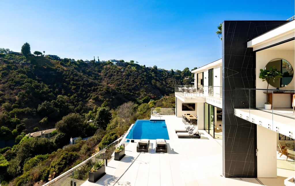 The Bel Air Home is an immaculately designed contemporary masterpiece with explosive canyon, ocean, and city views now available for sale. This home located at 1037 Stradella Rd, Los Angeles, California