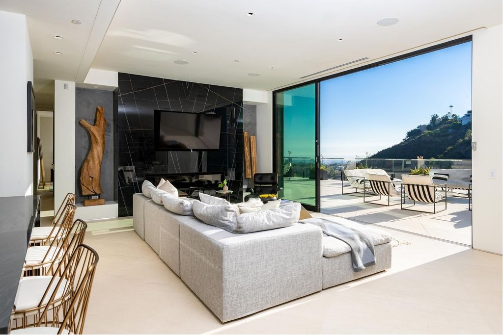 The Bel Air Home is an immaculately designed contemporary masterpiece with explosive canyon, ocean, and city views now available for sale. This home located at 1037 Stradella Rd, Los Angeles, California