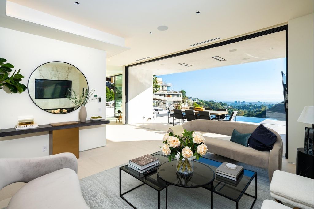 The Bel Air Home is an immaculately designed contemporary masterpiece with explosive canyon, ocean, and city views now available for sale. This home located at 1037 Stradella Rd, Los Angeles, California