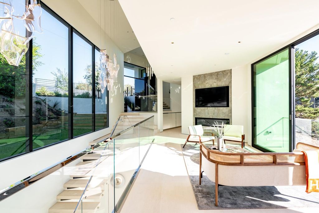 The Bel Air Home is an immaculately designed contemporary masterpiece with explosive canyon, ocean, and city views now available for sale. This home located at 1037 Stradella Rd, Los Angeles, California