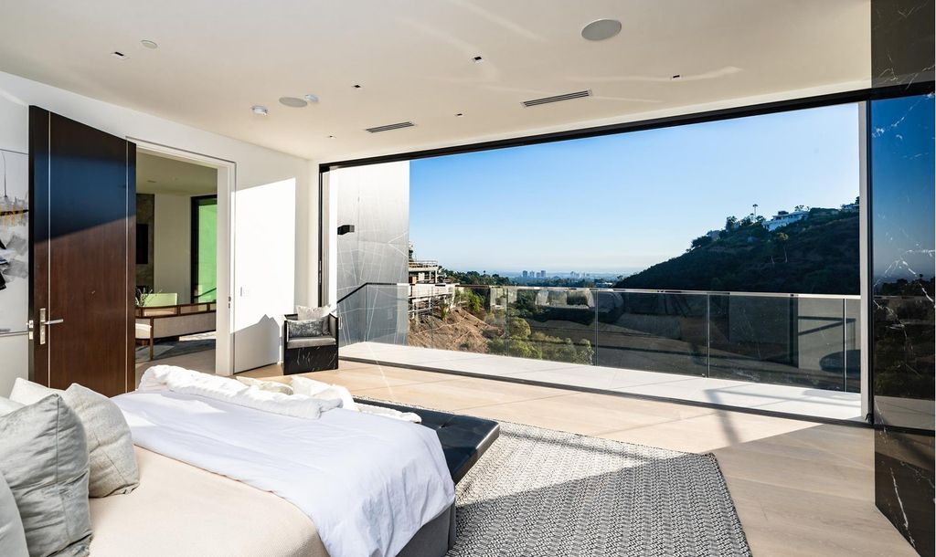 The Bel Air Home is an immaculately designed contemporary masterpiece with explosive canyon, ocean, and city views now available for sale. This home located at 1037 Stradella Rd, Los Angeles, California